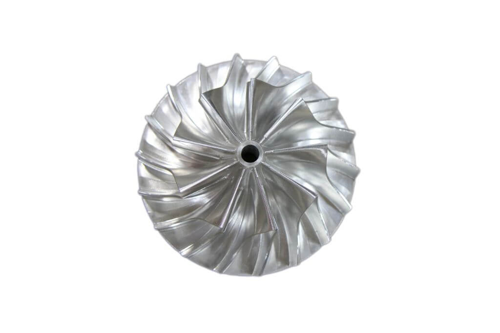 A shiny impeller with precision-machined curved blades.